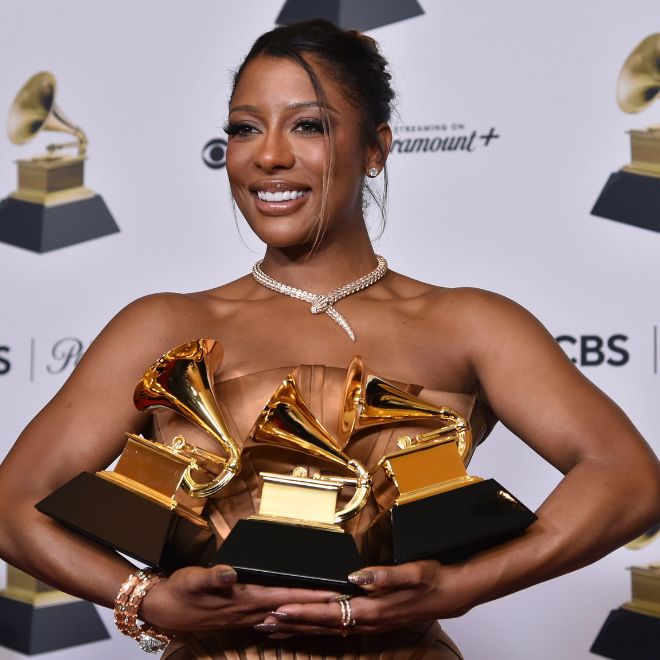 Victoria Monet poses in the press room with the awards for best new artist, best engineered album, non-classical and best R&B album for "Jaguar II," during the 66th annual Grammy Awards